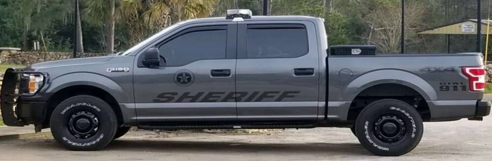 A gray Ford F150 truck with the word Sheriff written on it.